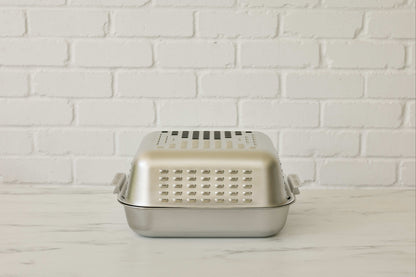 Stainless steel roasting pan with lid that keeps the oven clean and cooks a golden, juicy roast, crispy roast potatoes, crunchy pork crackling.